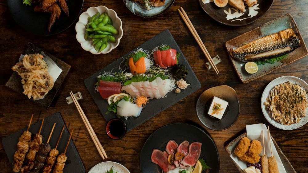 food on wooden table, grilled skewers to seasonal sashimi