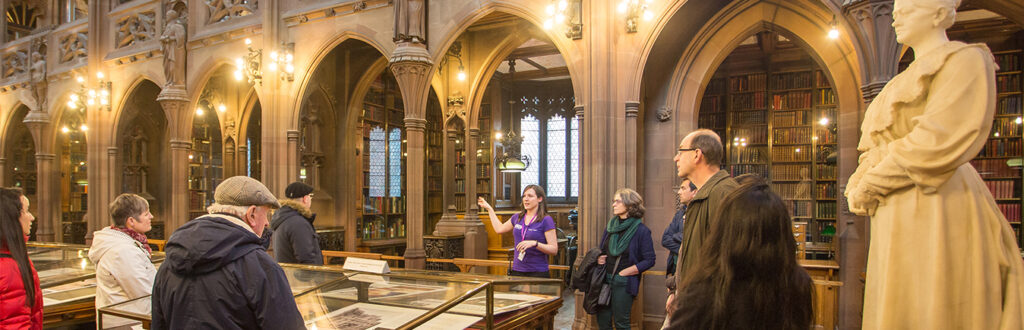 group of people inside the old library with books round