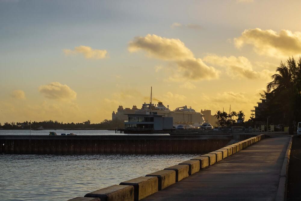 A Large ship docked at a pier at the Junkanoo Beach