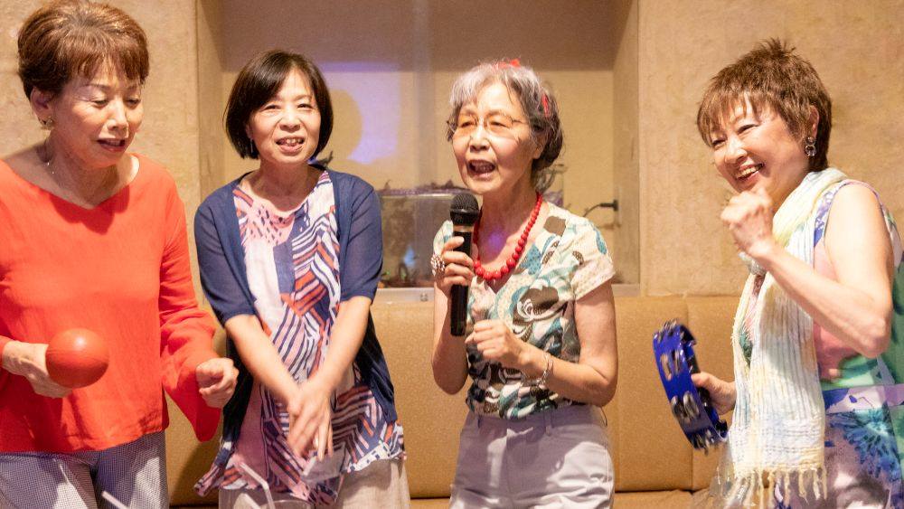 four old women singing karaoke