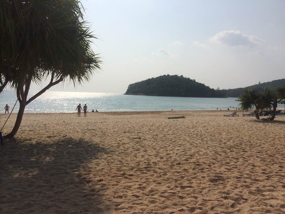 front view of the karon beach with people in the shore