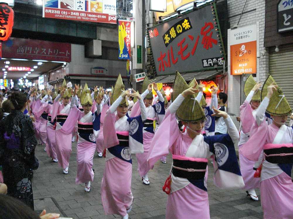 womens in pink Japanese kimono dancing in the street