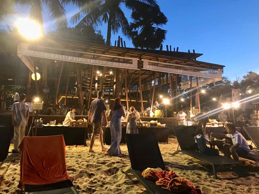 people in a beach club bar. koh samui vs phuket
