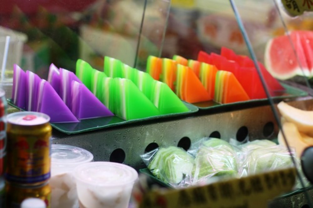 triangle shape rice cakes in purple green orange and red.
