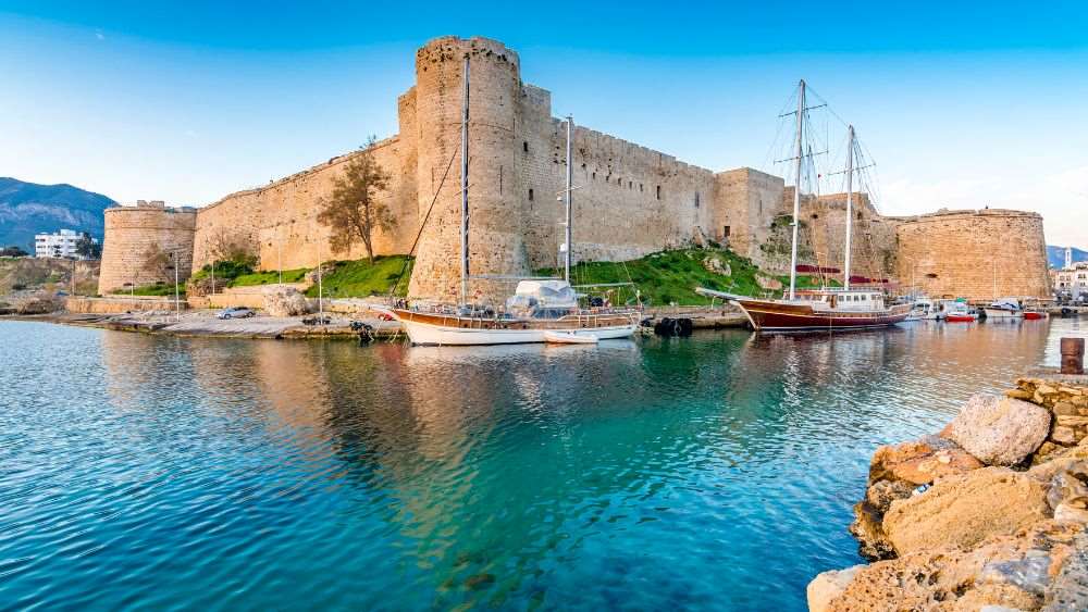 brown castle surrounded by boats in the middle of the ocean- cyprus digital nomad visa