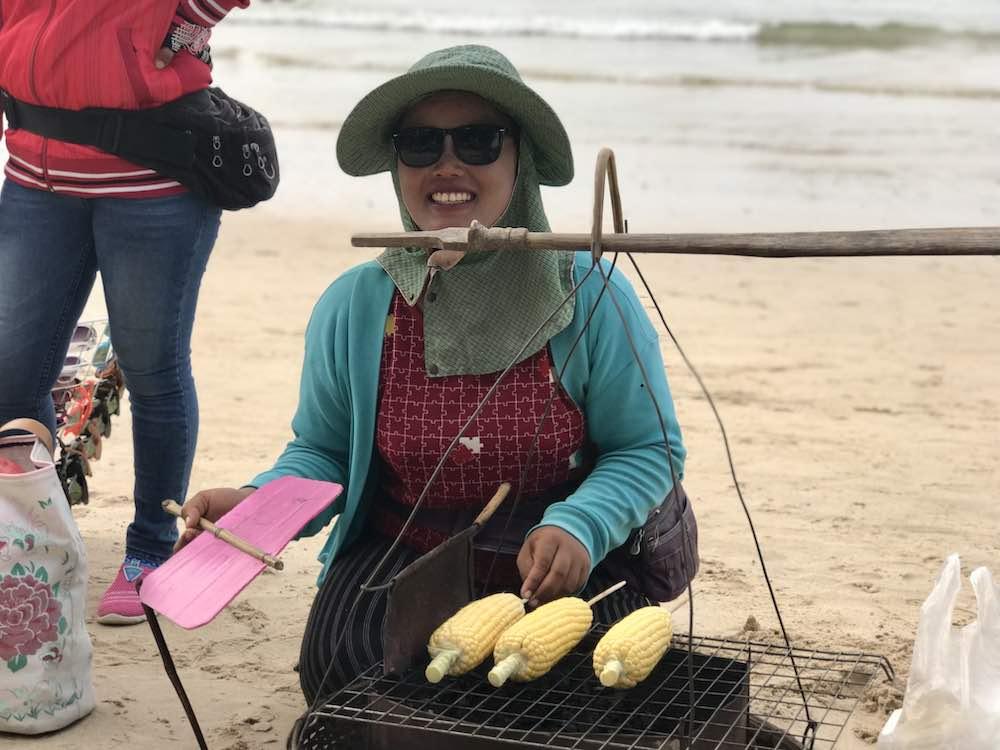 lady selling corn on beach