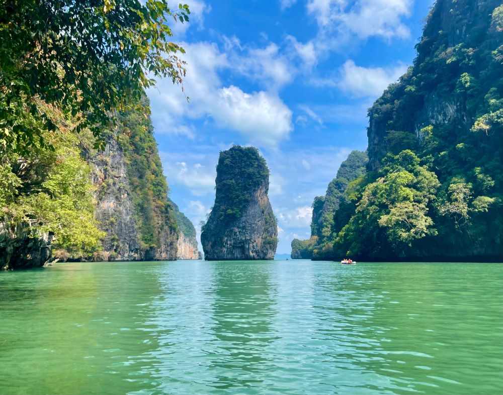 limestone cliff with green body of water