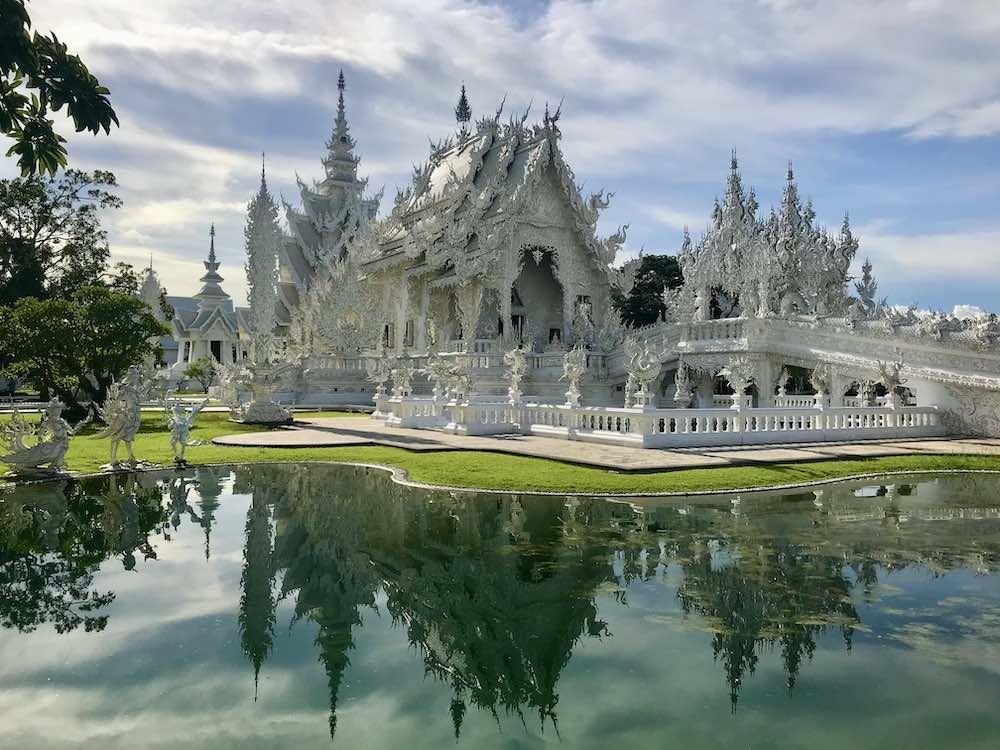 White temple beside a body of water named chiang rai white temple