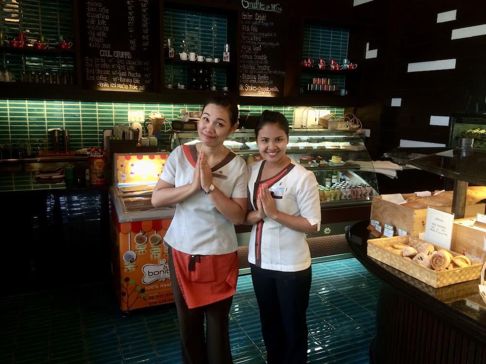 two woman in unform inside a cafe