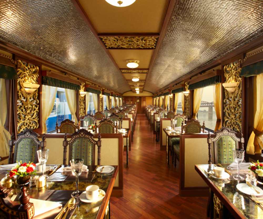 luxury chairs and tables inside the train - luxury train rides
