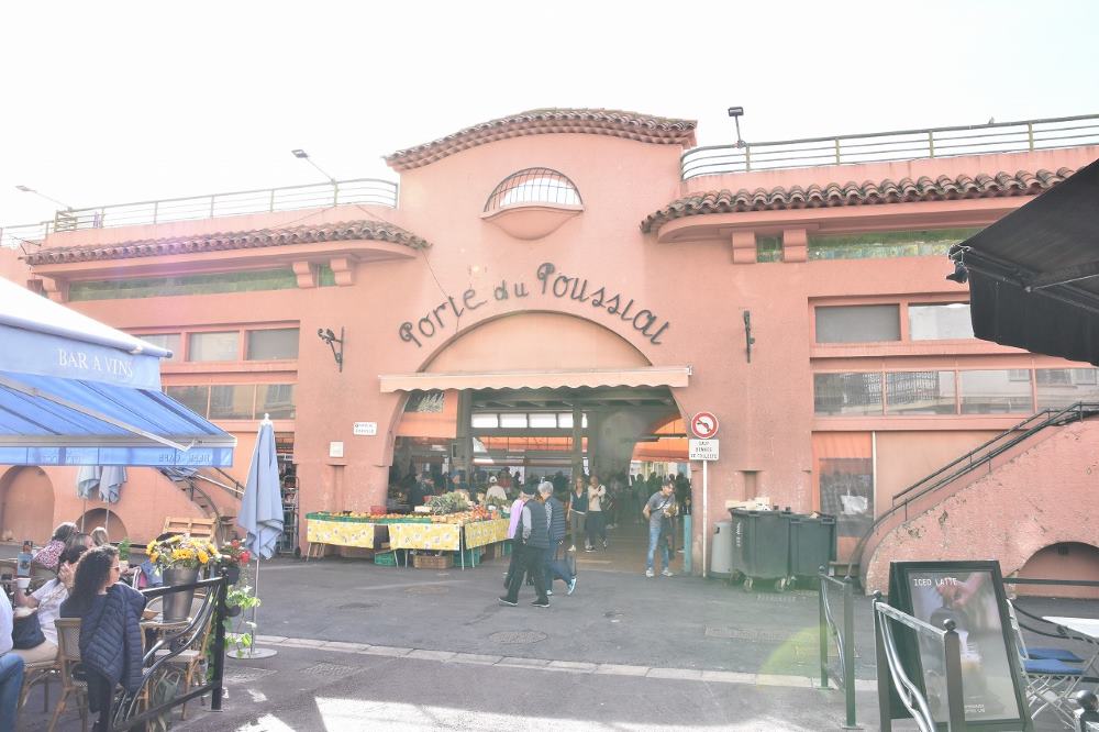 entrance of orange building known as the Marché Forville