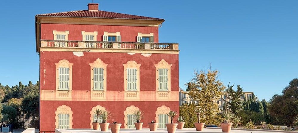 red building with pots with cactus in front of it- Things to do in Nice, France