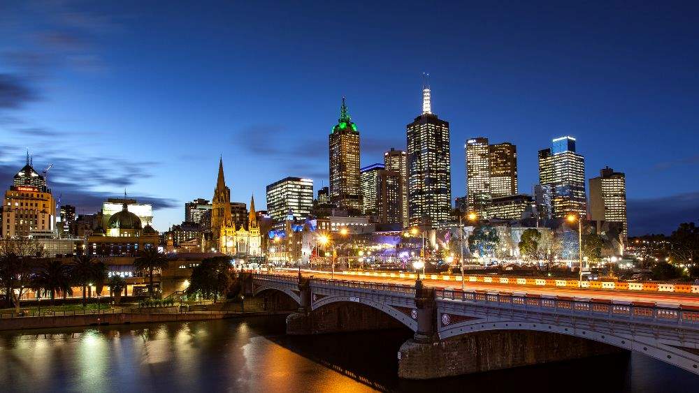 cityview showing high-rise buildings and city light near the bridge during night time - Exploring the Sydney to Melbourne Coastal Road Trip
