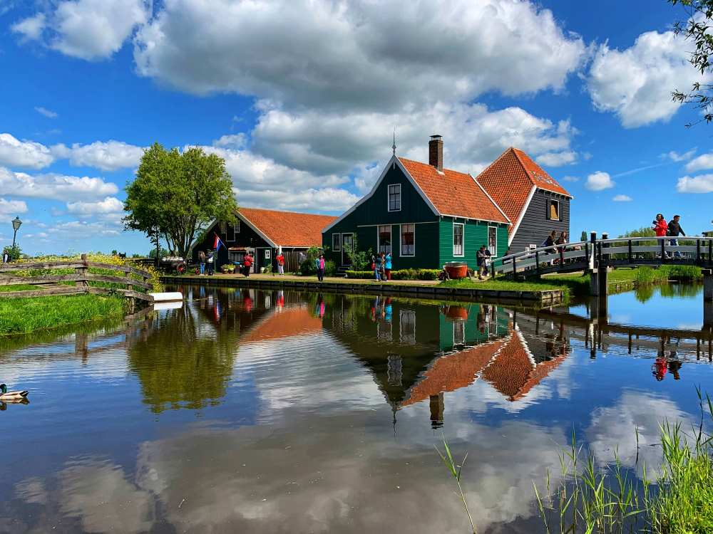 green house with foot bridge near body of water- netherlands digital nomad visa