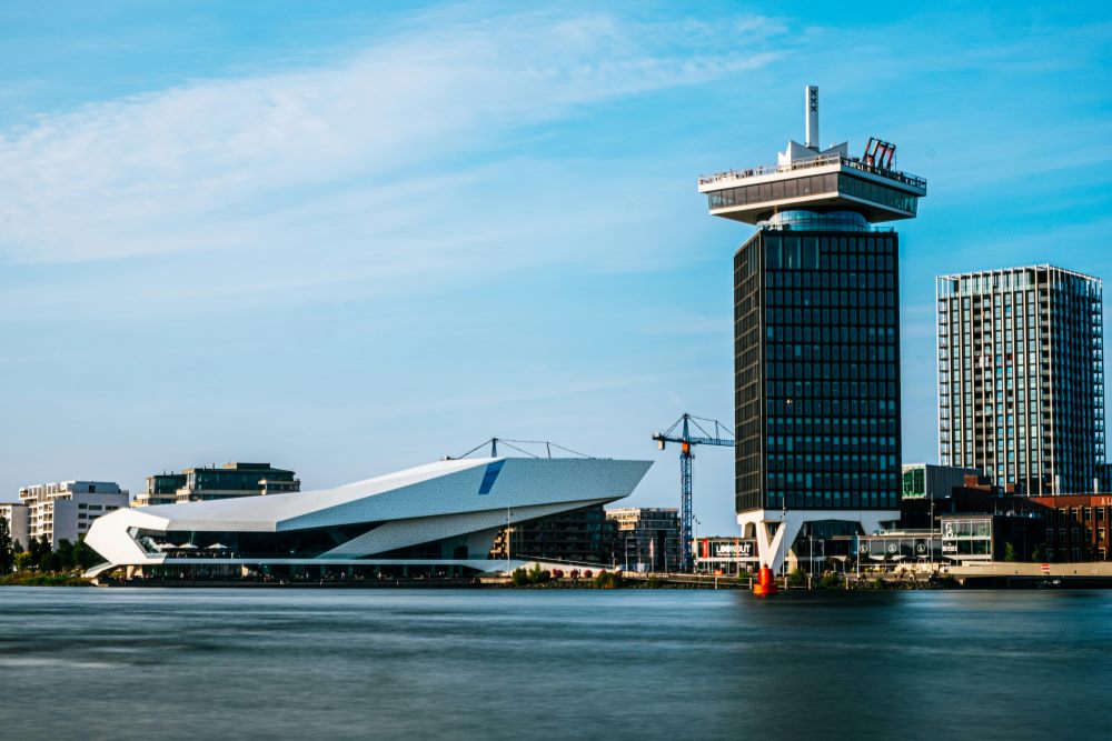 city view with high rise building near body of water - netherlands digital nomad visa