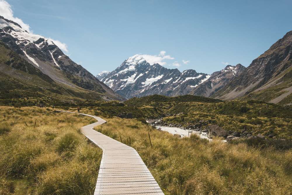 wooden brown pathway going to the mountain