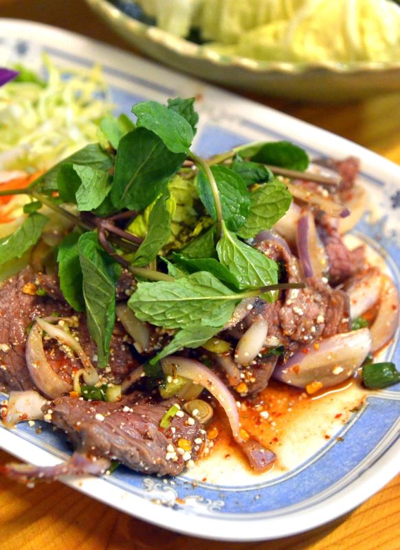 roasted beef with green leaves on top 