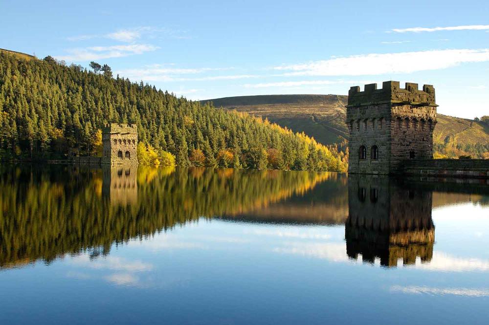 body of water with old concrete building and trees - 30 Unique Things to Do in Manchester UK