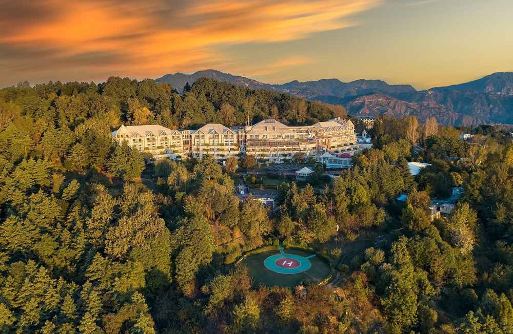aerial view of a hotel in the middle of the forest surrounded by green trees - unique hotels in the world