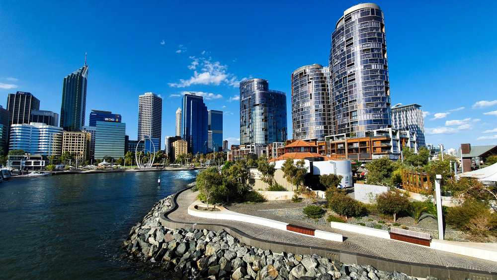 gray modern tall structure buildings near body of water