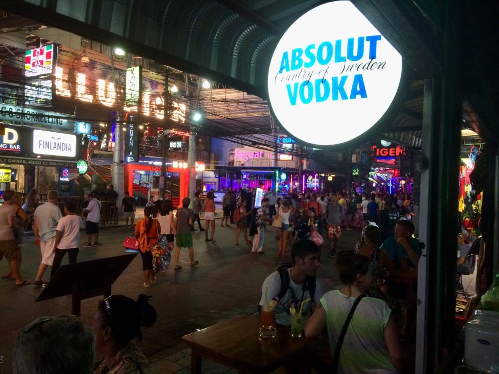 people walking around the street surrounded by clubs and bars -koh samui vs phuket