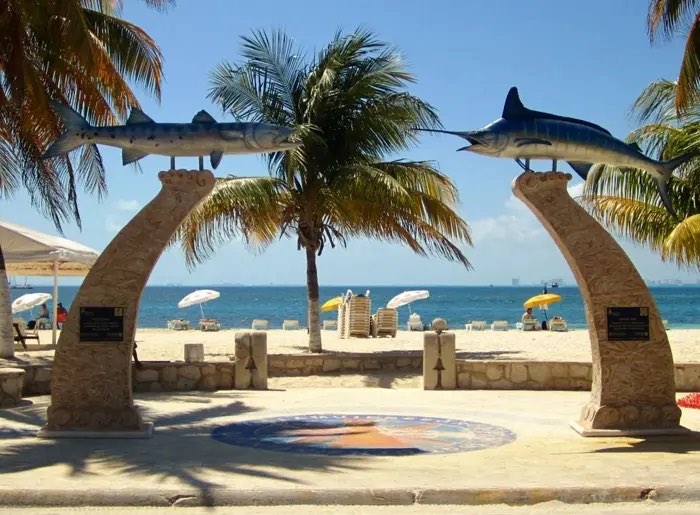 two arch statue with fish on top showing an entrance to the beach