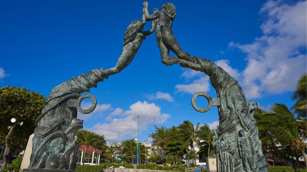 two statue holding hand up high