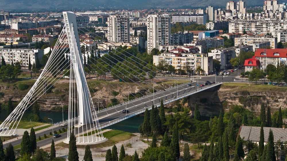 city view showing large bridge in the middle with green trees and hgih-rise buildings- montenegro digital nomad visa
