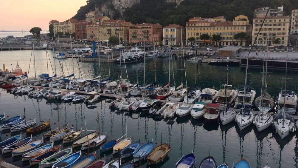 different size and color of boats and yacht line up at the port in the body of water
