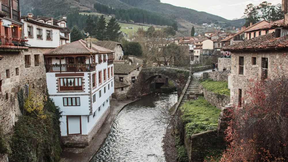 old brick houses and building with river in the middle