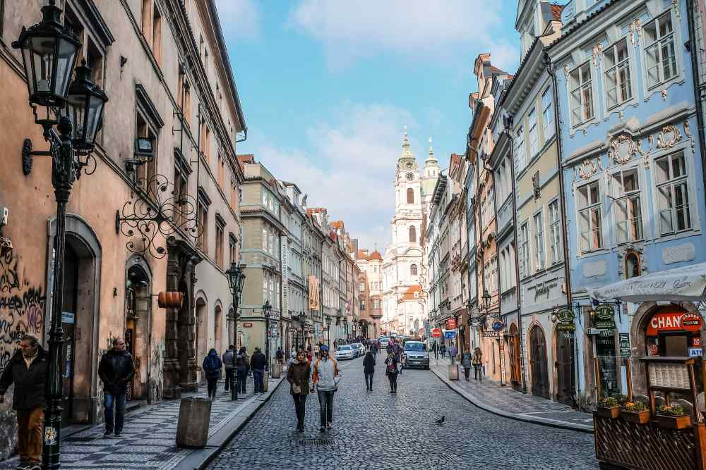 people walking in the street between buildings -czech republic digital nomad visa