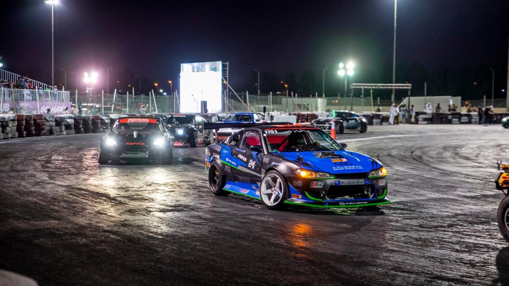cars racing during night time- Things to Do in Doha