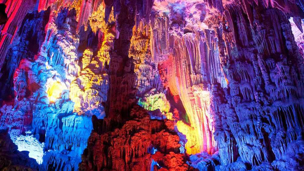 rock formation inside the cave with colorful lights - Underground Attractions