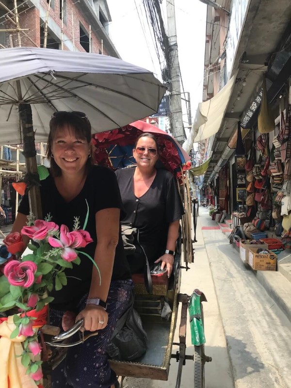 Me and my sister riding a tricycle while traveling through India