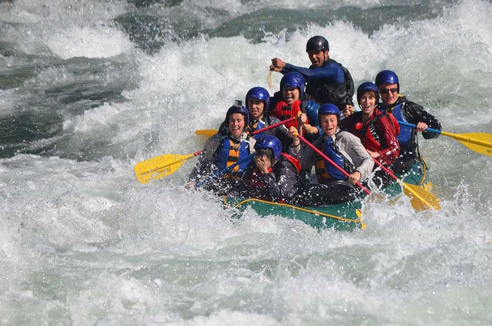 bunch of people with life vest enjoying river rafting