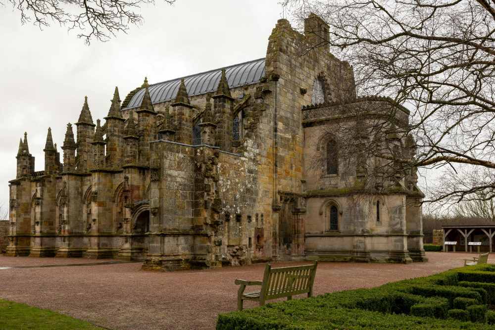 old structure chapel with old branch trees and grass- Things to Do in Scotland