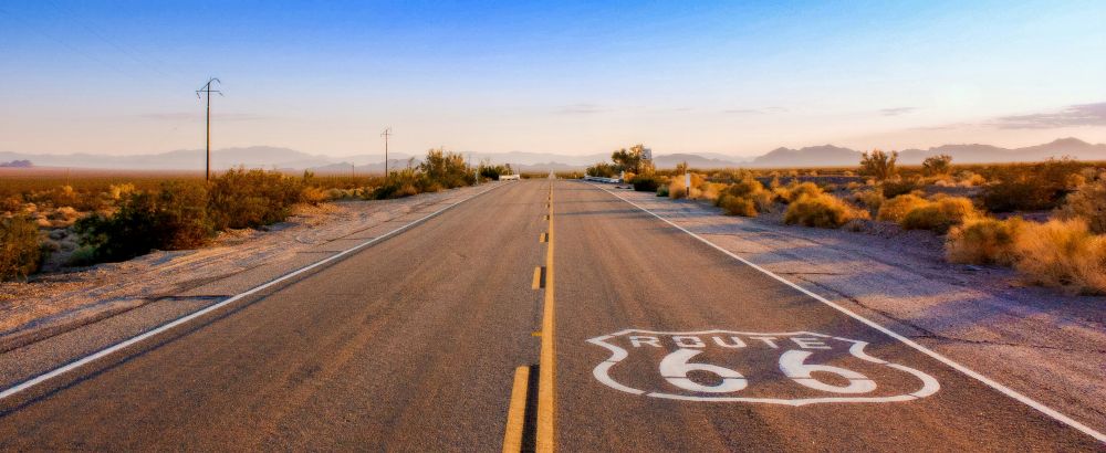 Road  with Route 66 White Signage at the road floor - Best road trips in the world