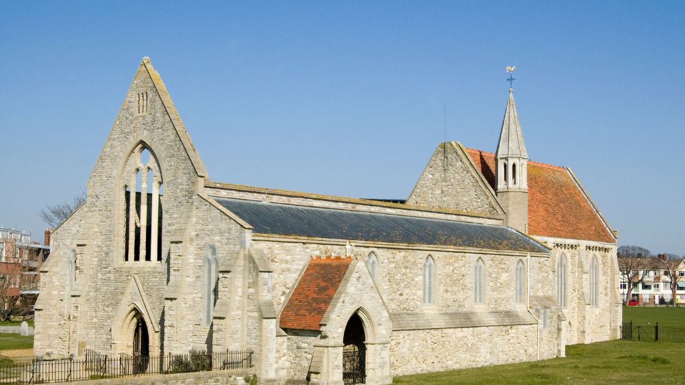 white gray old church with green grass