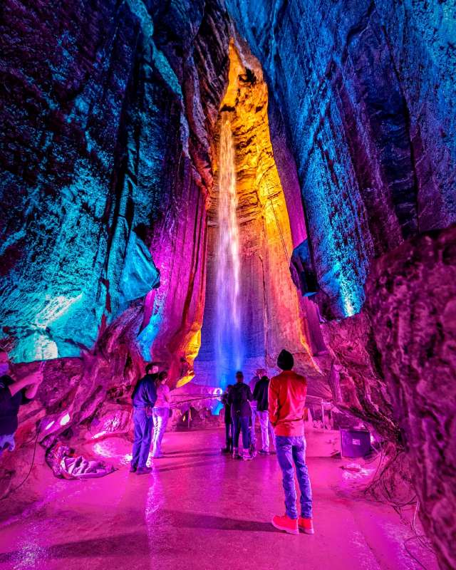 waterfalls inside the cave witrh red lights