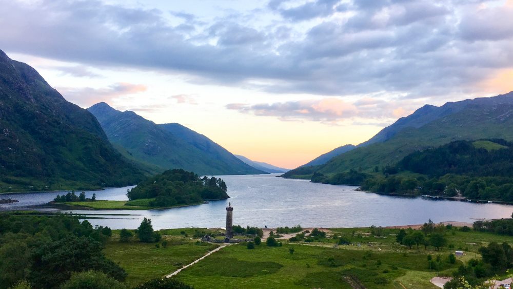 mountain and hill view surrounded by body of water- Things to Do in Scotland