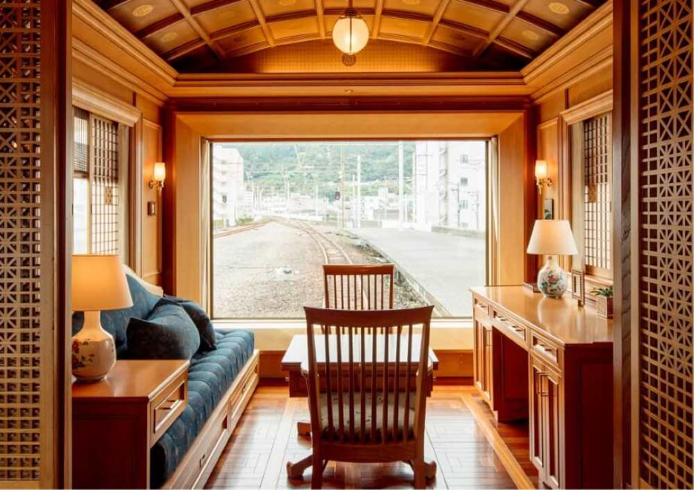 inside the train showing sofa and dinning table with 2 chairs
