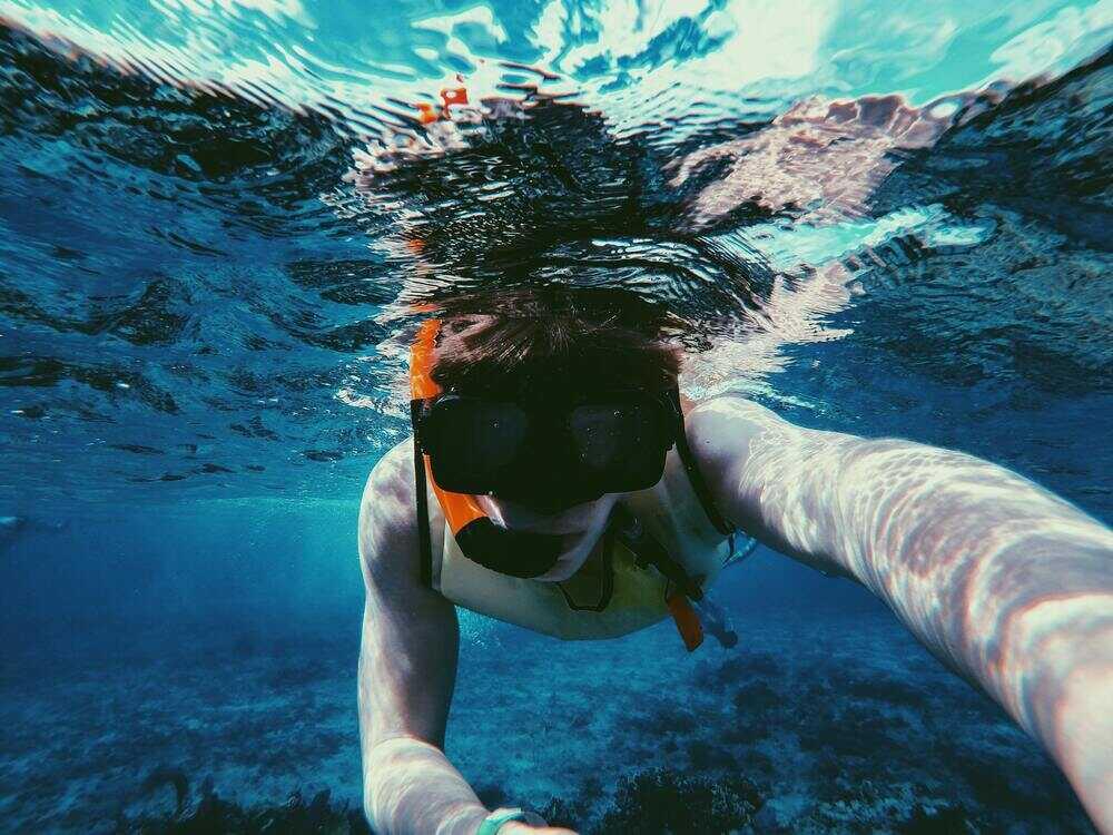 man in Snorkeling mask soak underwater in Arikok National Park