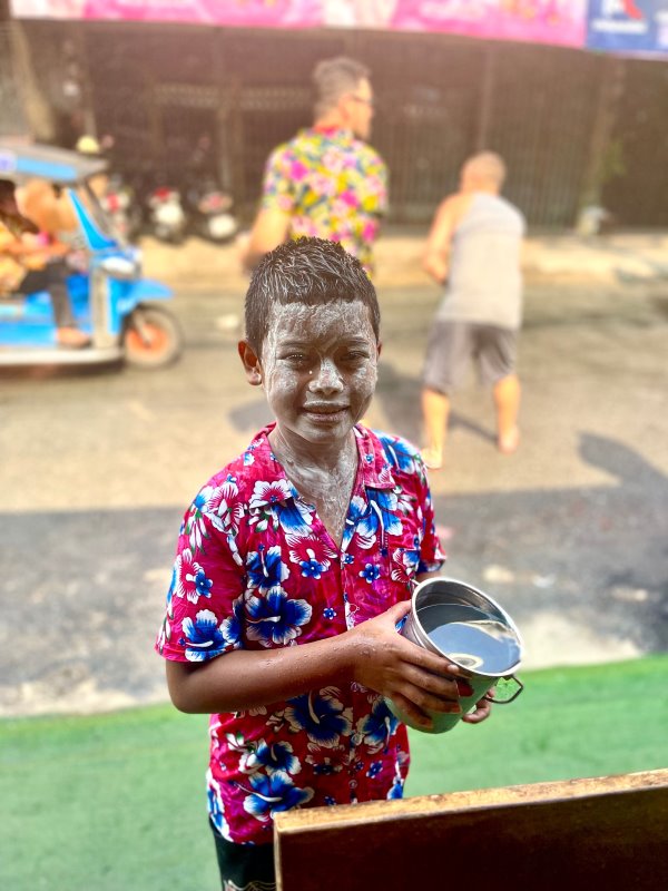 young man full of powder in his face ready for songkran