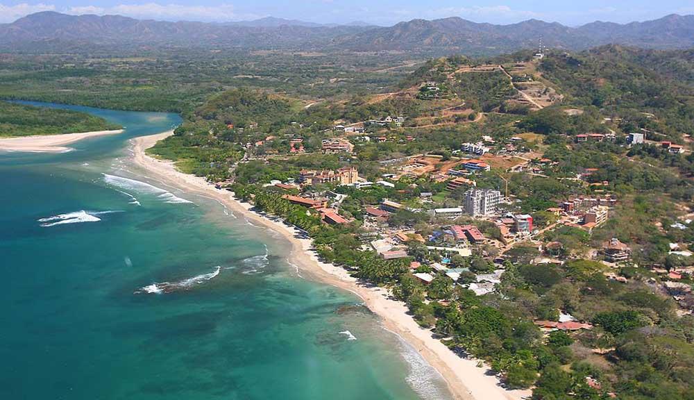 coastal village surrounded by lush jungle and pristine white sand beaches at Tamarindo Beach, Guanacaste
