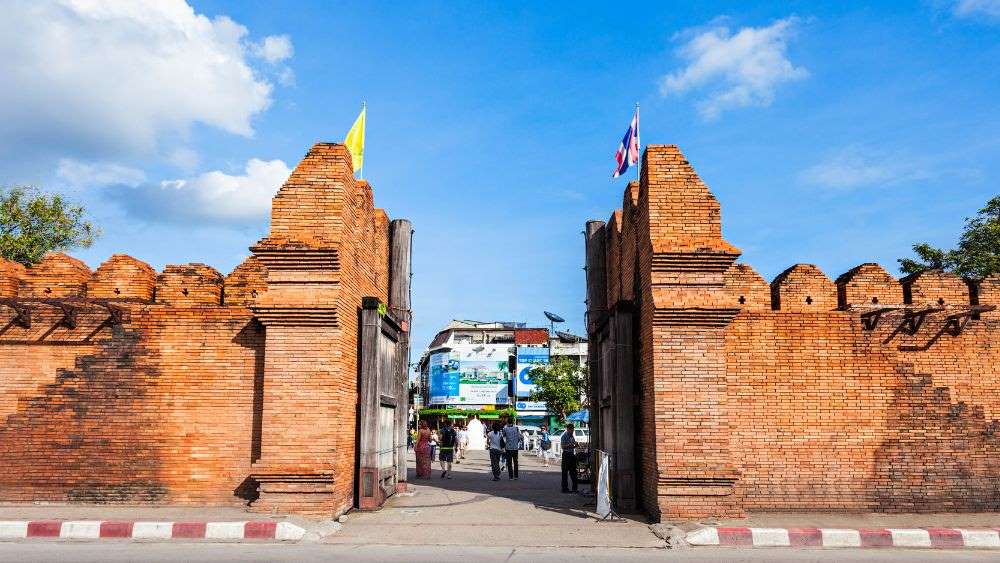 brown concrete gate showing entrance of the city- things to do in chiang mai