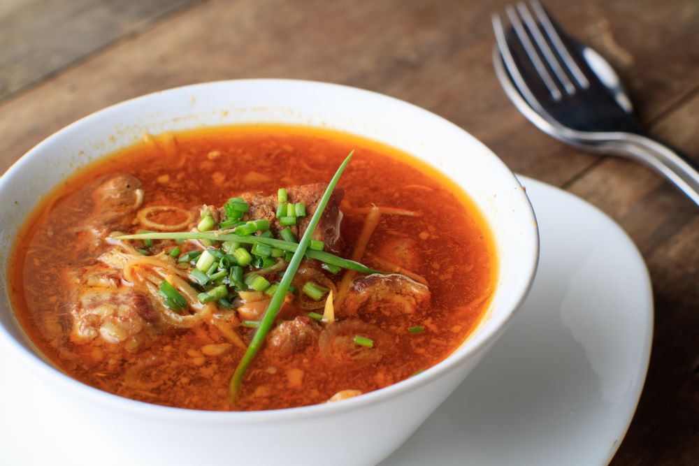 Thai food "Gaeng Hang lay" pork ginger peanut sweet and sour curry of pork the delicious food of Thai northern style in white bowl