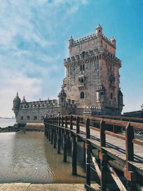 Belém Tower an old structure building near body of water - best cities for nomads