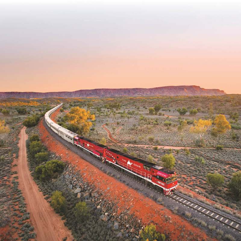 aerial view of red train in the middle of red dessert