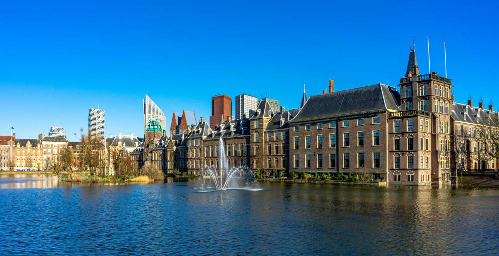 brown building structure in front of the water fountain- netherlands digital nomad visa