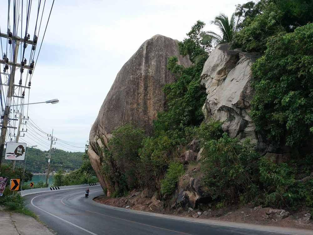 elephant hill and road with a man in motorcycle